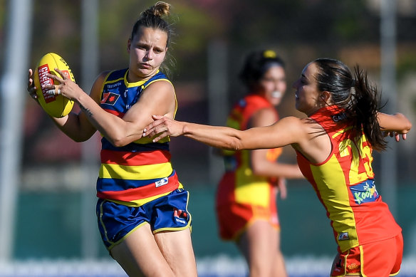 Danielle Ponter of the Crows tries to get around Gold Coast’s Meara Girvan.