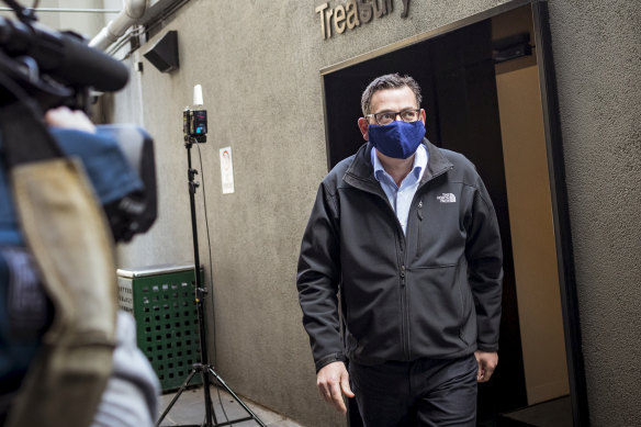 Daniel Andrews departs the daily COVID-19 press conference wearing a mask on Sunday.