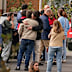 People searching for relatives who were traveling on the trains involved in a collision gather at a religious residence converted into a temporary medical facility in Toledo.