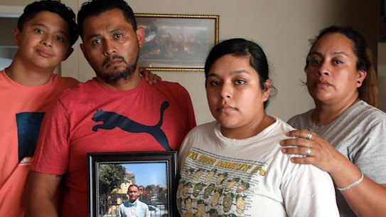 The Maldonado family, Benjamin Maldonado, Sr., second from left, and his wife Adriana Garcia right, with children Benjamine Maldonado, Jr, left, and Xitlali Raya Garcia, second from right, pose at their San Lorenzo, Calif. home on June 28, 2021, with a portrait of their son Jovani, 15, who was killed when a Tesla operating on autopilot rear-ended the family’s pickup truck. The family is suing Tesla, claiming its Autopilot system was partly responsible. 