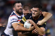 Panthers halfback Nathan Cleary is wrapped up by the Roosters’ James Tedesco.