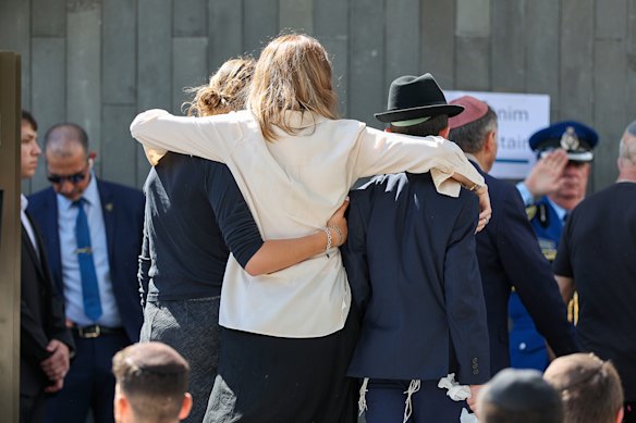 Mourners arrive at the funeral.