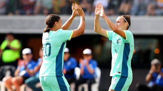 Caitlin Foord celebrates with skipper Sam Kerr.