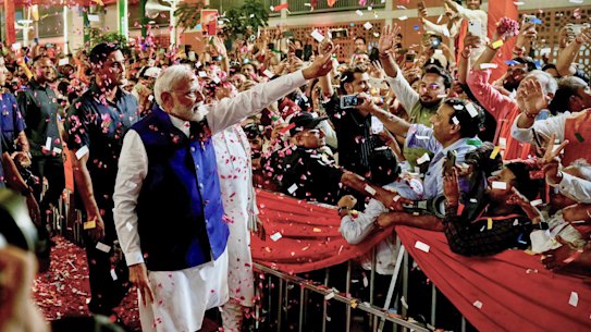 Prime Minister Narendra Modi is greeted by supporters as he arrives at his party’s headquarters in New Delhi.