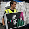 An Australian Border Force officer checks a stash of illegal cigarette imports.