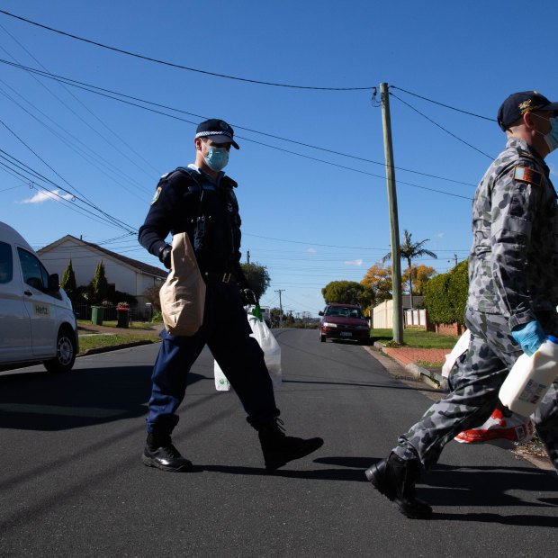 Police and ADF officers deliver groceries to people in isolation in the Fairfield LGA during Sydney’s lockdown.