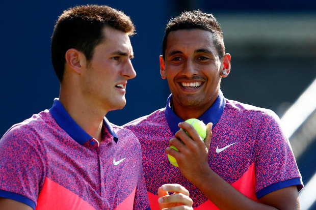 Bernard Tomic and Nick Kyrgios playing doubles at the 2014 US Open during a happier time.