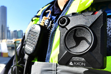 A police officer wears a body-worn camera.