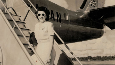 Up and away: freshly minted Qantas hostess Patricia Burke arrives for work in summer uniform, 1948.