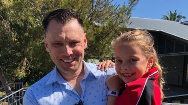 Martin from Melbourne is reunited with his daughter Leni, 6, in Newcastle after he received a travel permit to enter NSW.