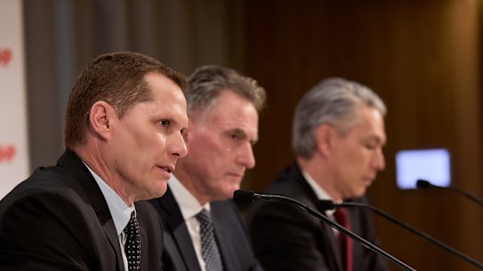 BHP's new boss Brandon Craig (left) speaks to the media with chairman Ross McEwan (centre) and outgoing CEO Mike Henry.
