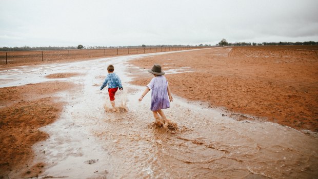 Dust to mud: the Paine children enjoyed Sunday's changing weather fortunes. 