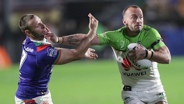 Milestone man: Raiders captain Josh Hodgson fends offs Warriors half Blake Green.