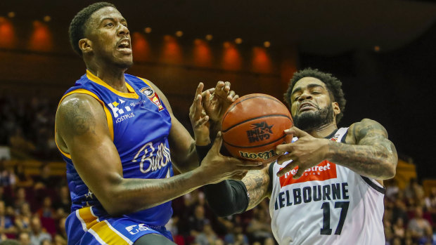 Lamar Patterson (left) of the Bullets drives to the basket during the round 8 NBL match against Melbourne United at the Brisbane Convention and Exhibition Centre on Saturday.