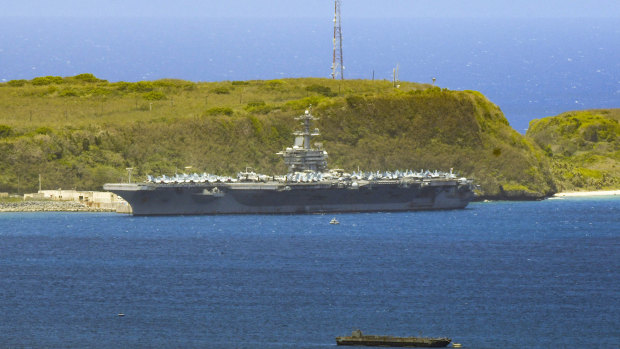 The USS Theodore Roosevelt, a Nimitz-class nuclear powered aircraft carrier, is docked along Kilo Wharf of Naval Base Guam.