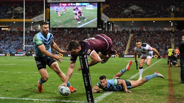 Get your Oates: The Queensland winger flies over for a try that, this time, stands. 