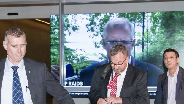 AFP officers leave the ABC Sydney building on June 5 after searching the broadcaster for information relating to a story about alleged abuses by Australian troops in Afghanistan.