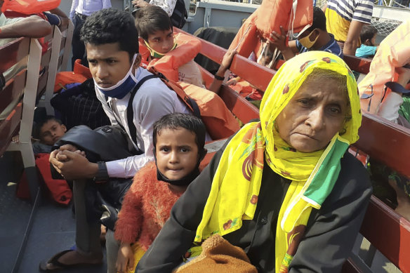 Rohingya refugees board a ship as they are ferried to Bhashan Char.