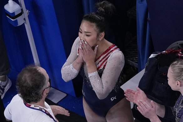 Lee reacts after getting her score for the floor apparatus