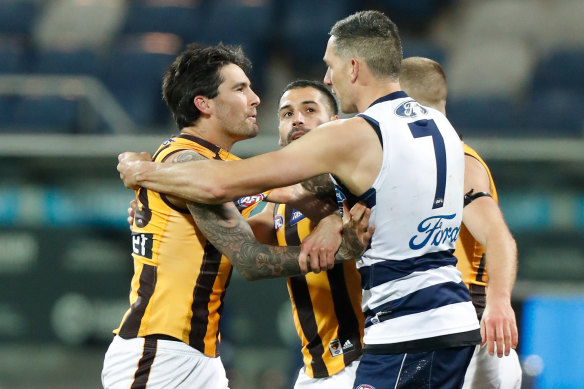 Chad Wingard and Harry Taylor of the Cats clash.