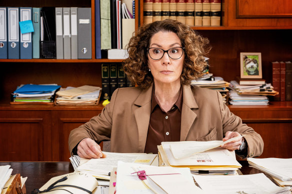 Brown is the working-woman’s wardrobe of choice for suburban lawyer Helen Tudor-Fisk (Kitty Flanagan). “Who can be bothered deciding what to wear every morning?”