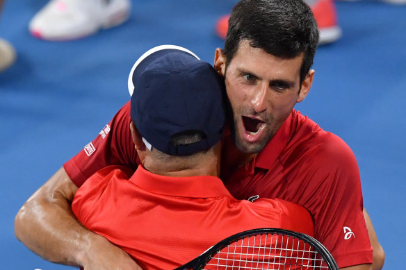 Djokovic hugs his doubles partner Viktor Troicki after defeating Edouard Roger-Vasselin and Nicolas Mahut.