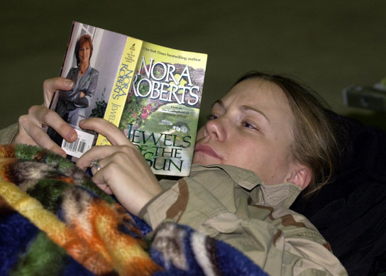 An American soldier takes a break as she makes her way back to the US from Iraq in February 2004.