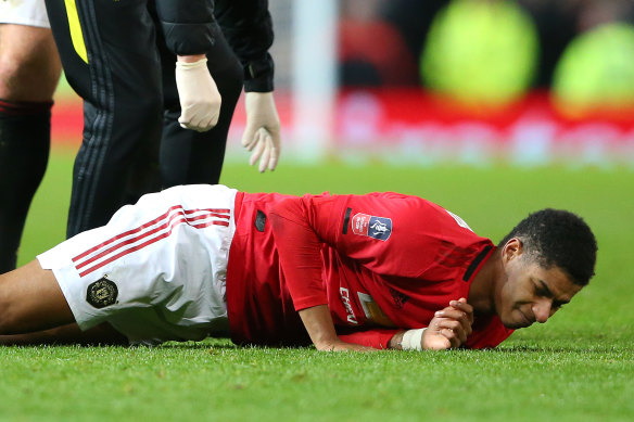 Marcus Rashford lies on the ground injured during the Wolves match.