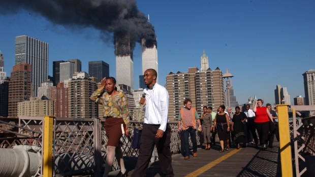 Smoke billowing out from the burning World Trade Centre, New York, viewed from the Brooklyn Bridge.