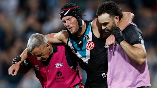 Brad Ebert is helped from the ground.