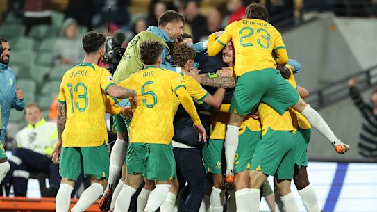 The Socceroos celebrate their third goal.