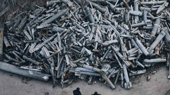 Police officers look at collected fragments of the Russian rockets that hit Kharkiv, Ukraine.