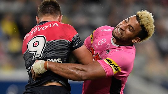 Penrith forward Viliame Kikau puts a hit on North Queensland's Reuben Cotter.
