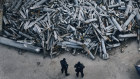 Police officers look at collected fragments of the Russian rockets that hit Kharkiv, Ukraine.