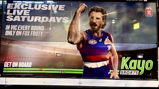 An advertisement for Kayo Sports promoting their exclusive Fox Footy AFL coverage on Saturdays.
