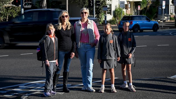  Parents Melissa Jones, in pink top, with her twins Lauren and Sophie, with Katrina Walker, in black outfit, and her daughter, Scarlett, on Albert Park Road near South Melbourne Park Primary school in Albert Park. 