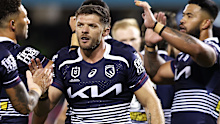 Corey Jensen celebrates a try with Broncos teammates.