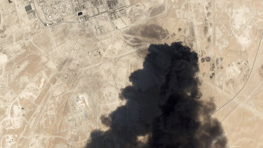 A satellite image from Planet Labs shows thick black smoke rising from Saudi Aramco's Abqaiq oil processing facility in Buqyaq, Saudi Arabia. 
