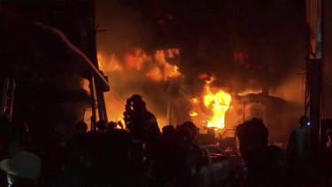Firefighters try to extinguish flames at buildings in Dhaka, Bangladesh.