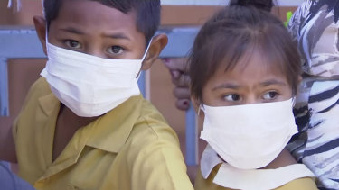 Masked children wait to get vaccinated at a health clinic in Apia, Samoa. 