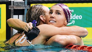 Australian swimmers Madison Wilson and Emma McKeon embrace after a race during Olympic trials.