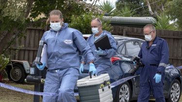 Forensic police arrive at a home in Melbourne's west on Tuesday, after two people were arrested on Monday night.