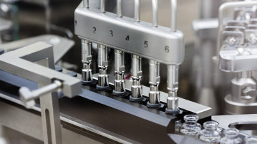 Rubber stoppers are placed onto filled vials of the investigational drug remdesivir at a Gilead manufacturing site in the United States.