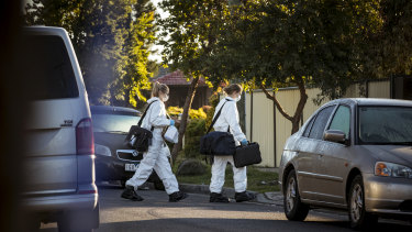 Forensic investigators enter the site of a death at 14 Nolan Street, Epping.