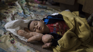 A Central American child who is travelling with a caravan of migrants sleeps at a shelter in Tijuana, Mexico, in April.