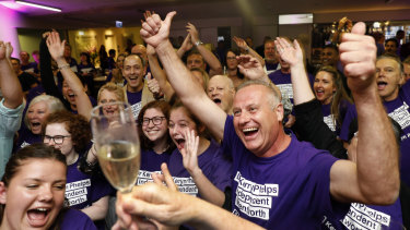 Supporters cheer as the ABC predict a win for Independent candidate Kerryn Phelps during a Wentworth byelection evening function.