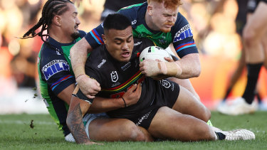 Spencer Leniu tries to wrestle past the Raiders defence.