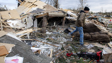 Hunter Lashley searches through the debris that was his home near Beauregard.