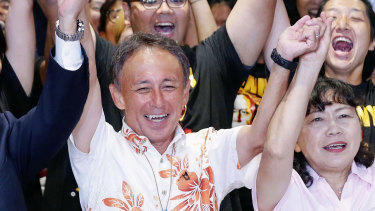 Japan's legislator Denny Tamaki, centre, celebrates his victory with supporters in the election for Okinawa governor in Naha city on  Sunday.