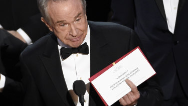 Presenter Warren Beatty holds up an envelope revealing “Moonlight” as the winner of best picture at the Oscars on Sunday, Feb. 26, 2017, at the Dolby Theatre in Los Angeles. (Photo by Chris Pizzello/Invision/AP)